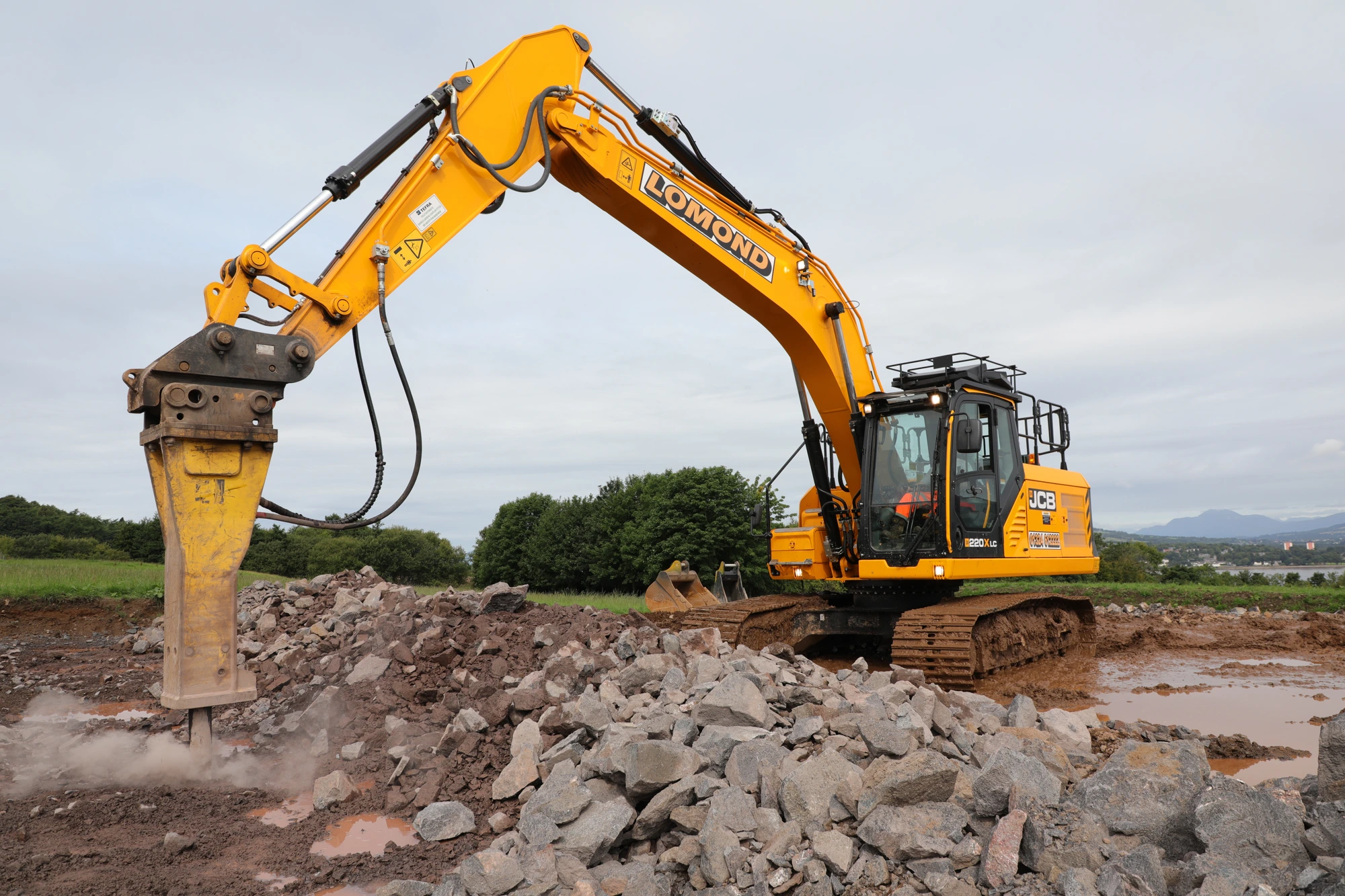 Lomond excavator with breaker attachment at work